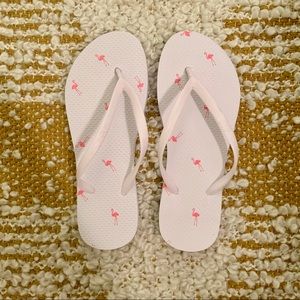 White Gap flip flops with flamingos